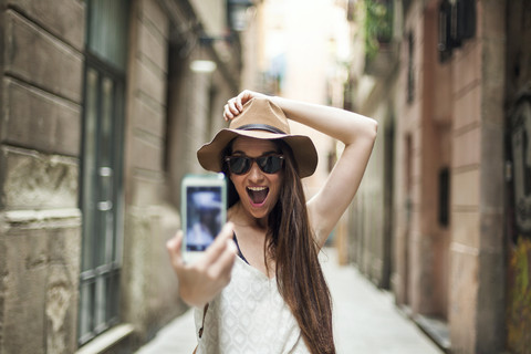Young tourist discovering streets of Barcelona, taking selfie stock photo