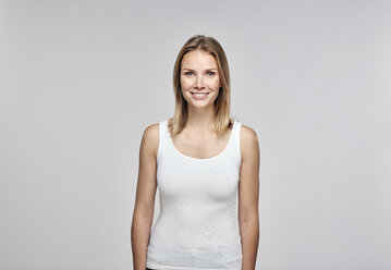 Portrait of smiling blond woman wearing white top - RHF001641