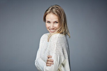 Portrait of smiling blond woman with arms crossed - RHF001644