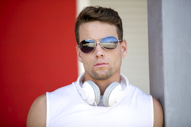 Porträt eines Mannes mit verspiegelter Sonnenbrille und Kopfhörern - GDF001029