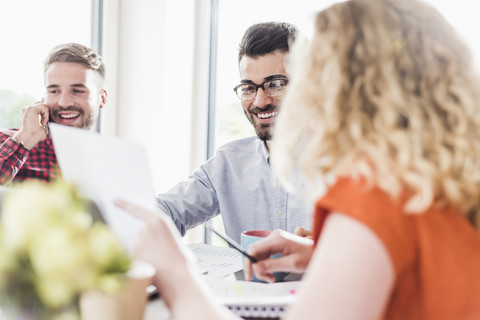 Smiling young professionals working in office stock photo