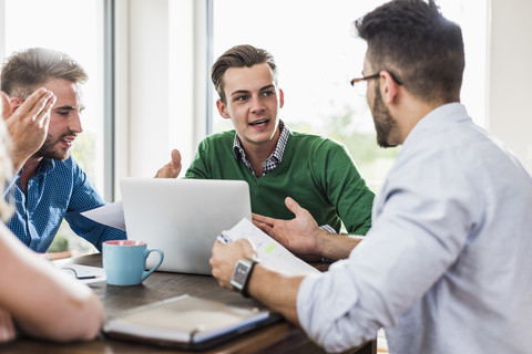 Young professionals arguing in office stock photo