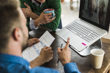 Colleagues having a video conference in office - UUF007877