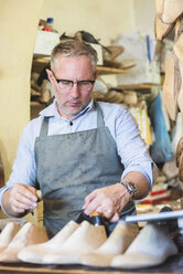 Cobbler making shoes in his workshop - FMOF000036