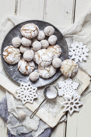 Home-baked Christmas cookies with powdered sugar on old book stock photo