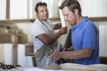 Two men working in canvas workshop - ZEF008834