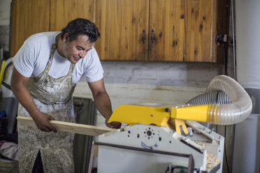 Man cutting wood in workshop - ZEF008838