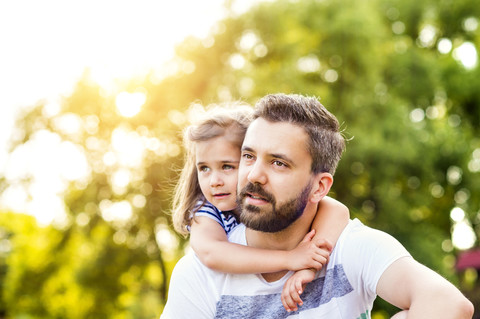 Porträt eines Vaters mit seiner kleinen Tochter Kopf an Kopf, lizenzfreies Stockfoto