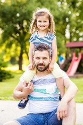 Portrait of father with little daughter on his shoulders - HAPF000554