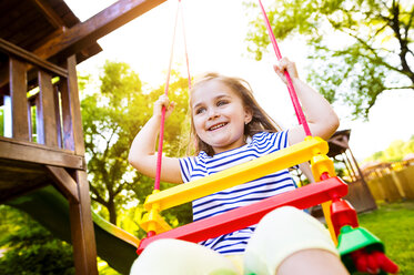 Portrait of happy little girl on a swing - HAPF000558