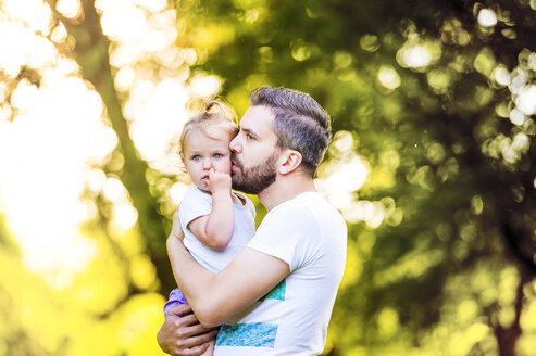 Father holding his little daughter on his arms - HAPF000561