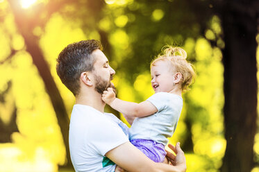 Father holding little daughter on his arms - HAPF000562