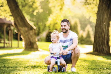 Father and his little daughter with toy car in a park - HAPF000563