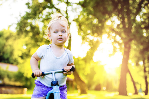 Porträt eines kleinen Mädchens mit Spielzeugauto in einem Park - HAPF000564