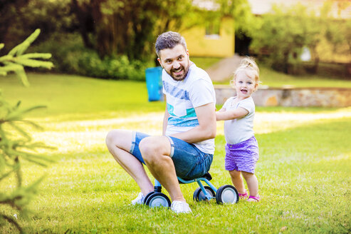 Father and his little daughter with toy car in a park - HAPF000565