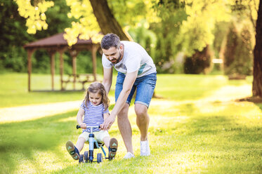 Father and his little daughter with toy car in a park - HAPF000566