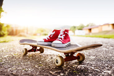 Red sneakers on a skateboard - HAPF000590