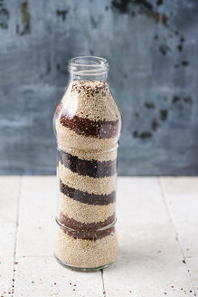 Glass bottle of three layered sorts of quinoa - MYF001681
