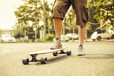 Man with longboard, partial view stock photo