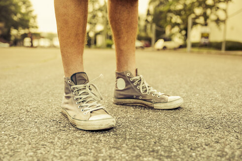 Man's feet with old sneakers, close-up - SKAF000024