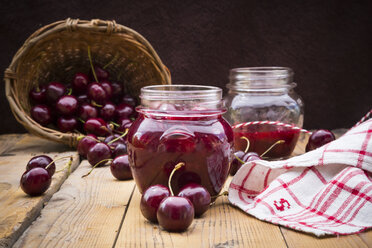 Glasses of homemade cherry groats, dish towel and cherries on wood - LVF005067