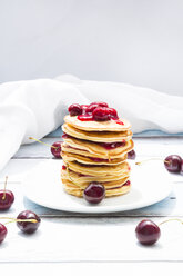 Stack of American pancakes with cherries and cherry groats - LVF005074