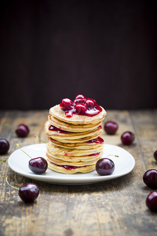 Stack of American pancakes with cherries and cherry groats stock photo