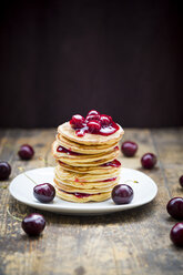 Stack of American pancakes with cherries and cherry groats - LVF005078