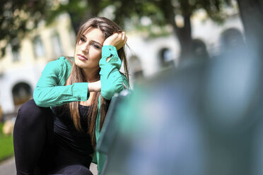 Young woman sitting on bench - SIPF000589