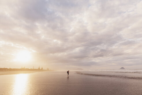 New Zealand, North Island, Bay of Plenty, Ohope Beach, man watching ocean waves, South Pacific Ocean - GWF004772