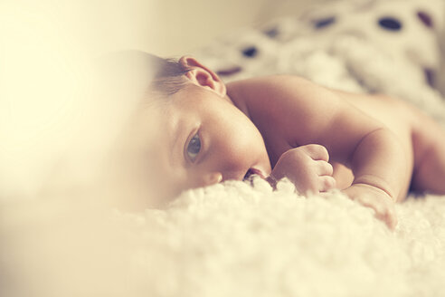 Weibliches Baby auf weißem Fell liegend - YNF000018