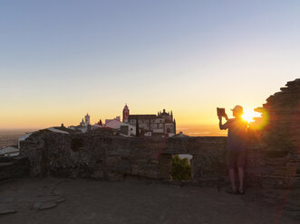 Portugal, Älterer Mann fotografiert den Sonnenaufgang am Castel de Monsaraz - LAF001697