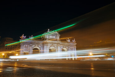 Spain, Madrid, The Puerta de Alcala with flashes of cars at night - KIJF000505