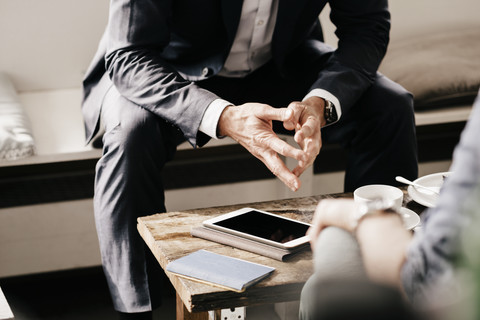 Businessman consulting customer in cafe stock photo