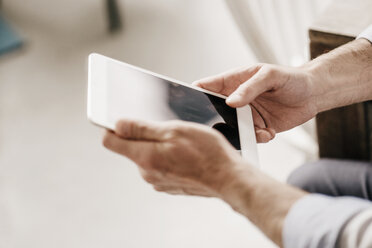 Hands of businessman holding digital tablet - KNSF000025