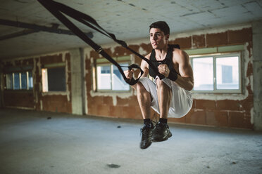 Junger Mann beim Suspensionstraining trx, Springen - RAEF001275