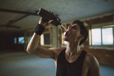 Young man after suspension training trx, drinking - RAEF001281