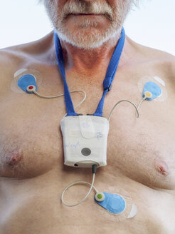 Senior man with long-term ECG on his chest, close up - LAF001704