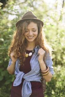 Portrait of smiling young woman hiking - AKNF000046