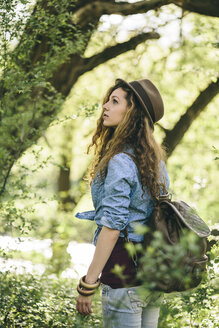 Portrait of hiking young woman watching something - AKNF000052