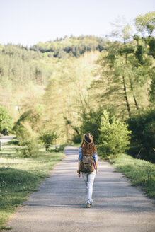 Back view of young woman hiking - AKNF000060