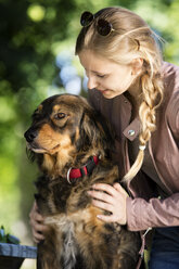 Happy woman with her mongrel - MIDF000740