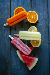 Orange, lemon and watermelon snow ice cream on blue wood - KIJF000517