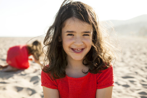 Portrait of happy little girl on the beach stock photo