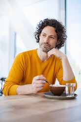 Portrait of pensive man with cup of Cappuccino - DIGF000571