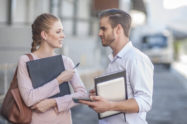 Businessman and woman discussing work - ZEF009043