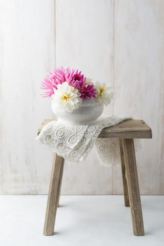 Bowl of dahlias on a stool stock photo