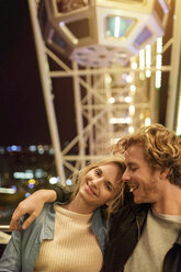 Young couple at fun fair with arms around - PES000237