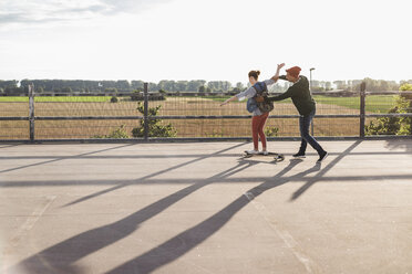 Junges Paar mit Skateboard auf Parkdeck - UUF008102