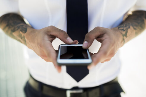 Man's hands text messaging, close-up - GIOF001254